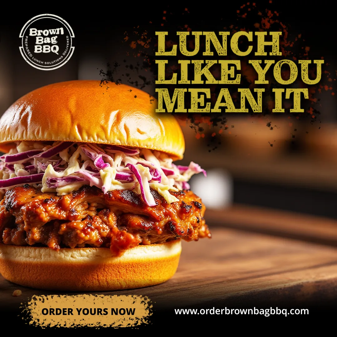Barbecue sandwich topped with slaw on a brioche bun
