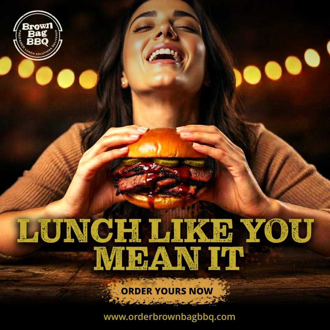 Woman laughing with eyes closed, holding a brisket sandwich