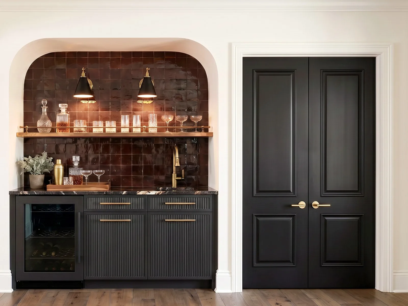 Rendered recreation room bar: brown glazed tile in an arched niche, brass sconces, black fluted cabinetry and black double doors